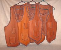  These three two toned vests were all bought by the same guy for his bartender employees. They all have split lapels, pointed yokes on the back, as well as, the four pockets done with a simple braid. The picture is linked to a page with several more pictures of these  features. 