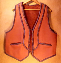 This two tone moccasin cowhide leather vest has rather unique lapels and back yoke - that back yoke can be better seen by going to the page the picture is linked to. It also has the two slanted slit pockets 