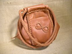  A unique leather handbag with an 'infinity hearts' applique on one of the pockets. 